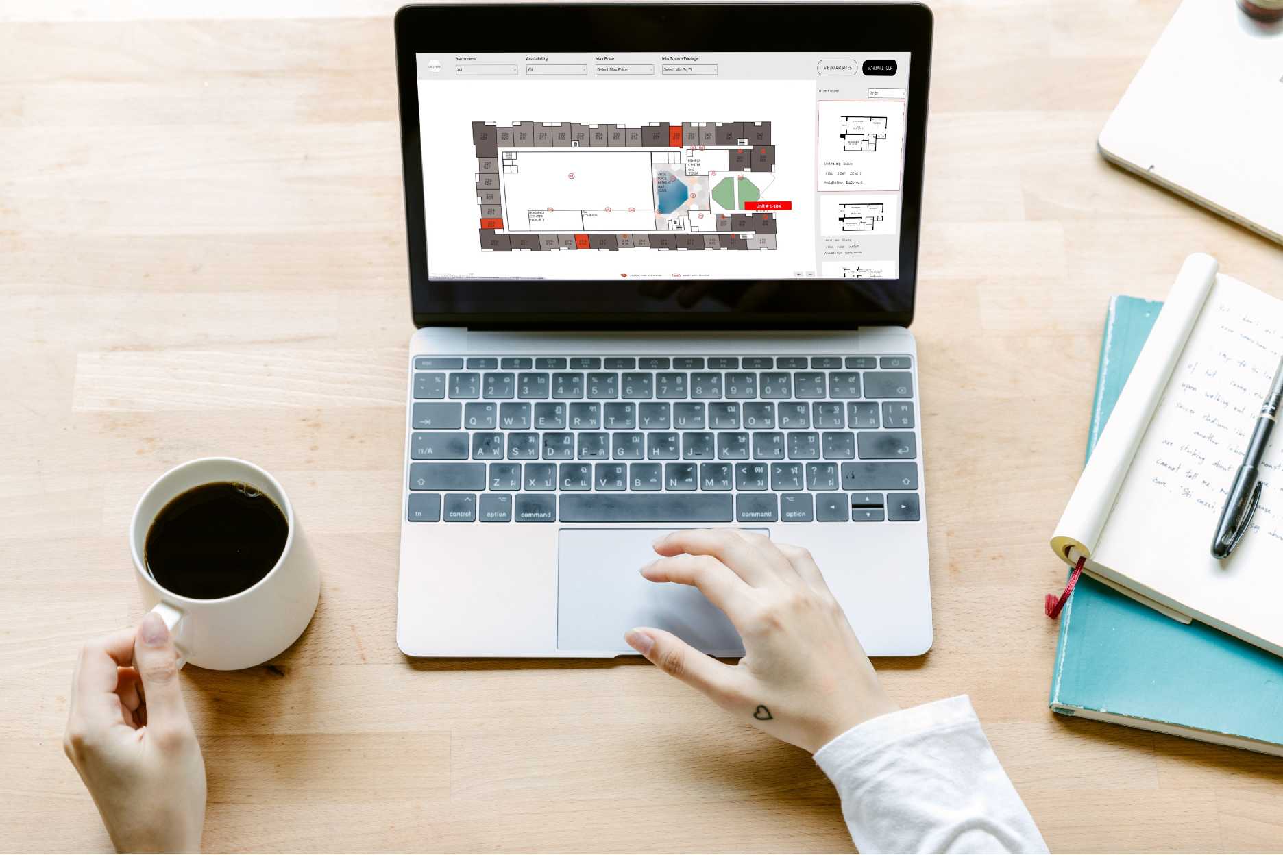 Two women sitting at a table using Pynwheel interactive property website map to search for apartments